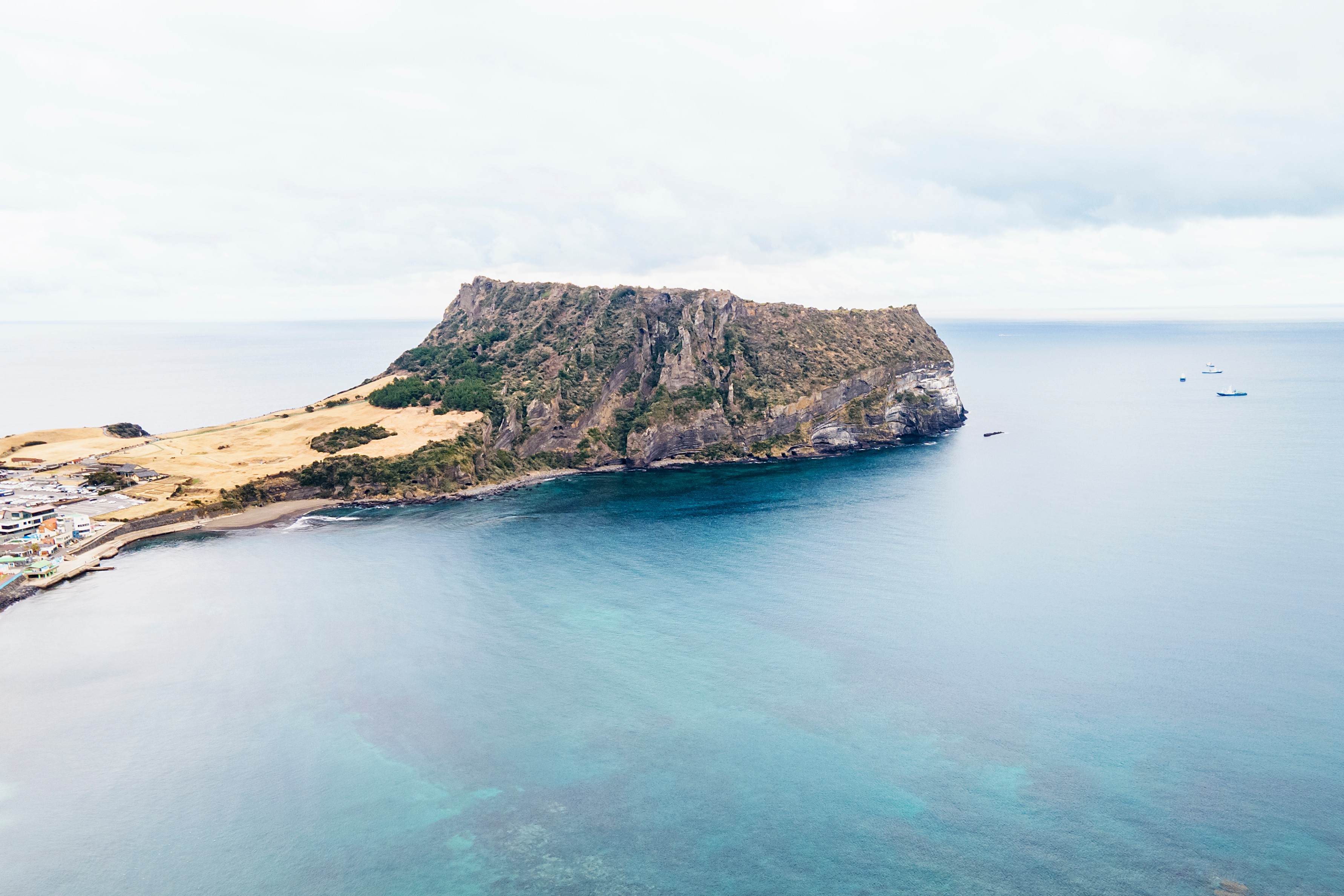 Seongsan Ilchulbong volcanic peak rising from the sea on Jeju Island